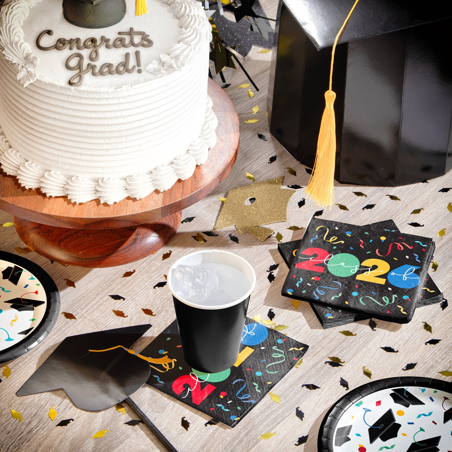 Graduation-themed table setting with cake, cap, and napkins with 'Class of 2026' text