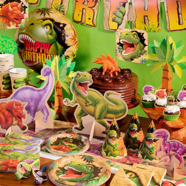 Dinosaur themed plates, cups and decorations displayed on a table