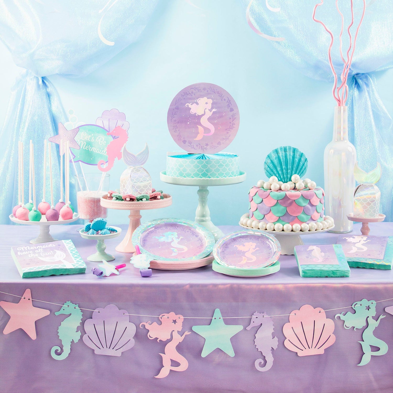 Iridescent Mermaid Party Supplies displayed on a table