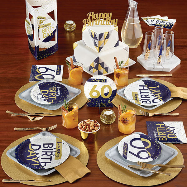 Navy and Gold Milestone party supplies on a table