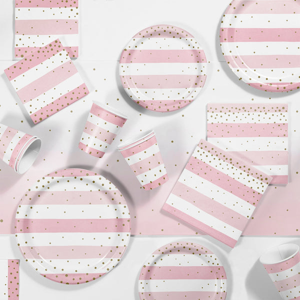 Pink and Gold Celebration Party Supplies. Pink and white striped plates, napkins and cups with gold polka dots displayed on a table