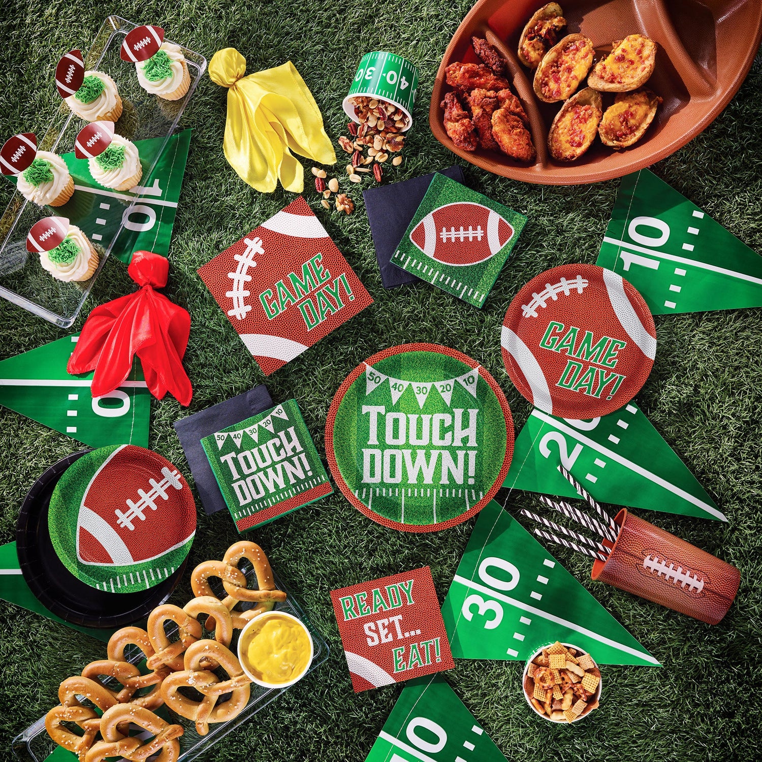 Tailgate Time Party Supplies tableware displayed on a green grass background