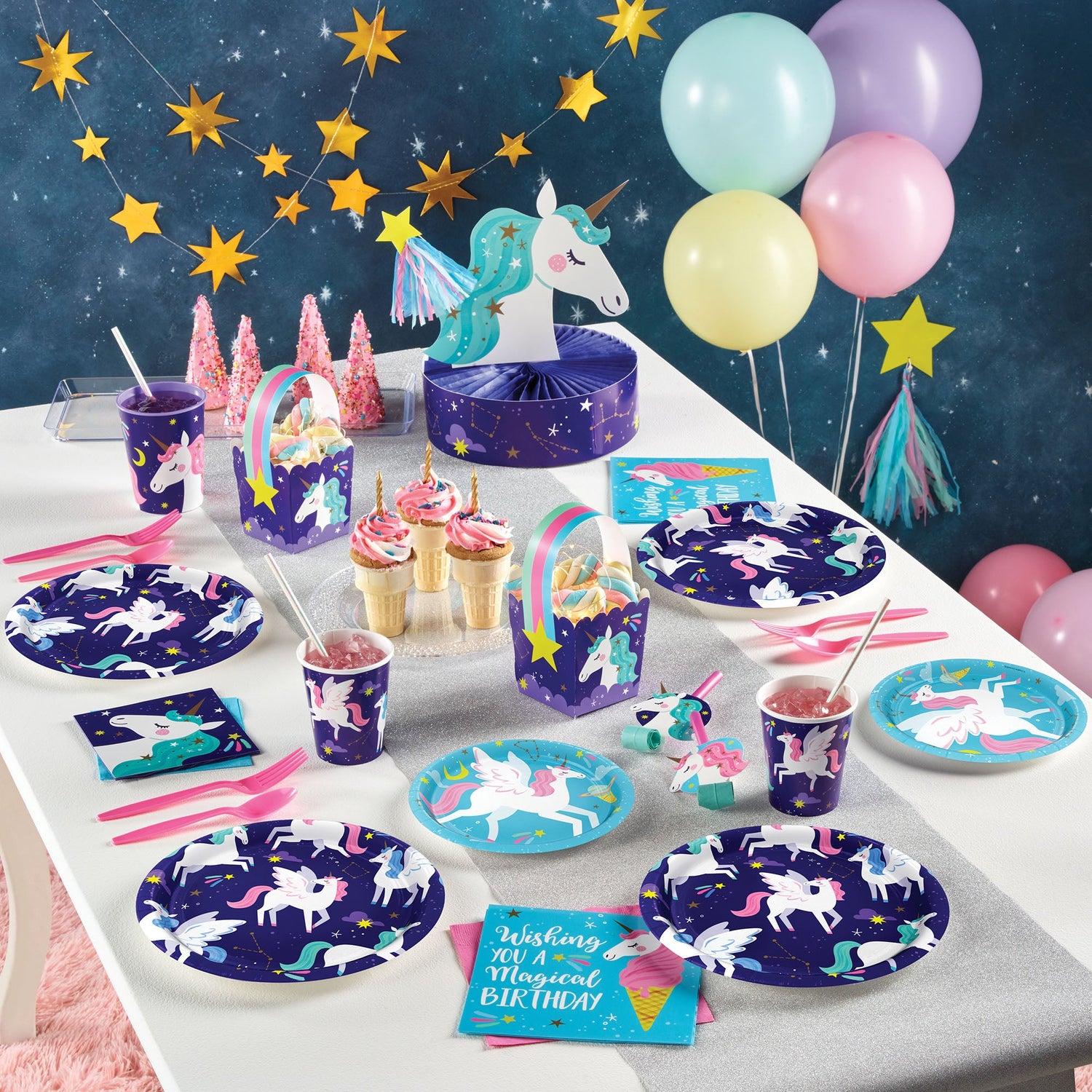Unicorn Galaxy Party Supplies displayed on a table