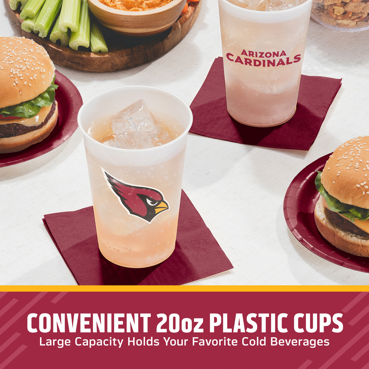 Arizona Cardinals themed 20oz plastic cups shown on a table with burgers, celery, and drinkware. One clear cup has the Arizona Cardinals logo, another has 'ARIZONA CARDINALS' text, and both are filled with iced beverages on burgundy napkins.