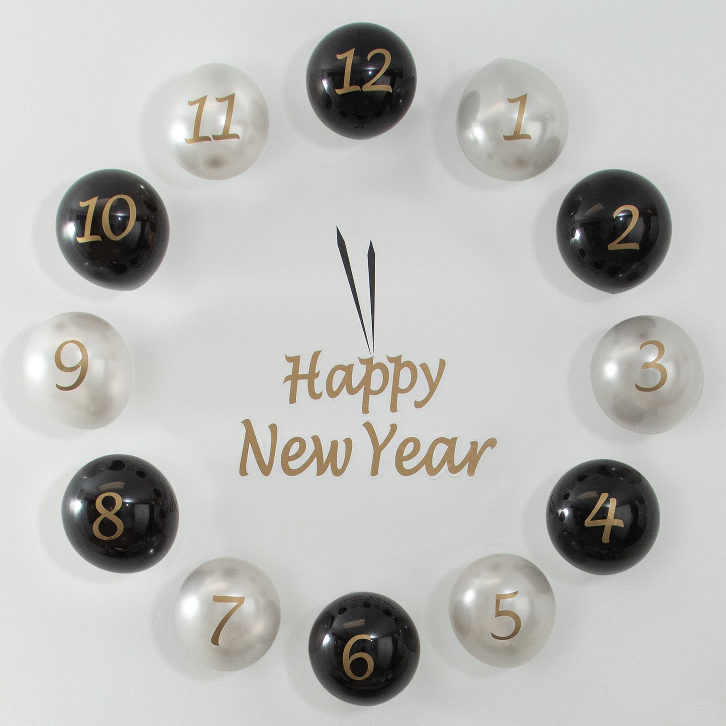Decorative countdown clock with numbered black and silver balloons spelling 'Happy New Year' on a light background