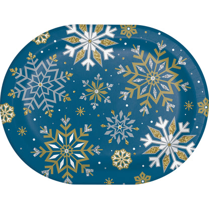 Decorative oval paper plate with gold, silver and white snowflake pattern on a blue background