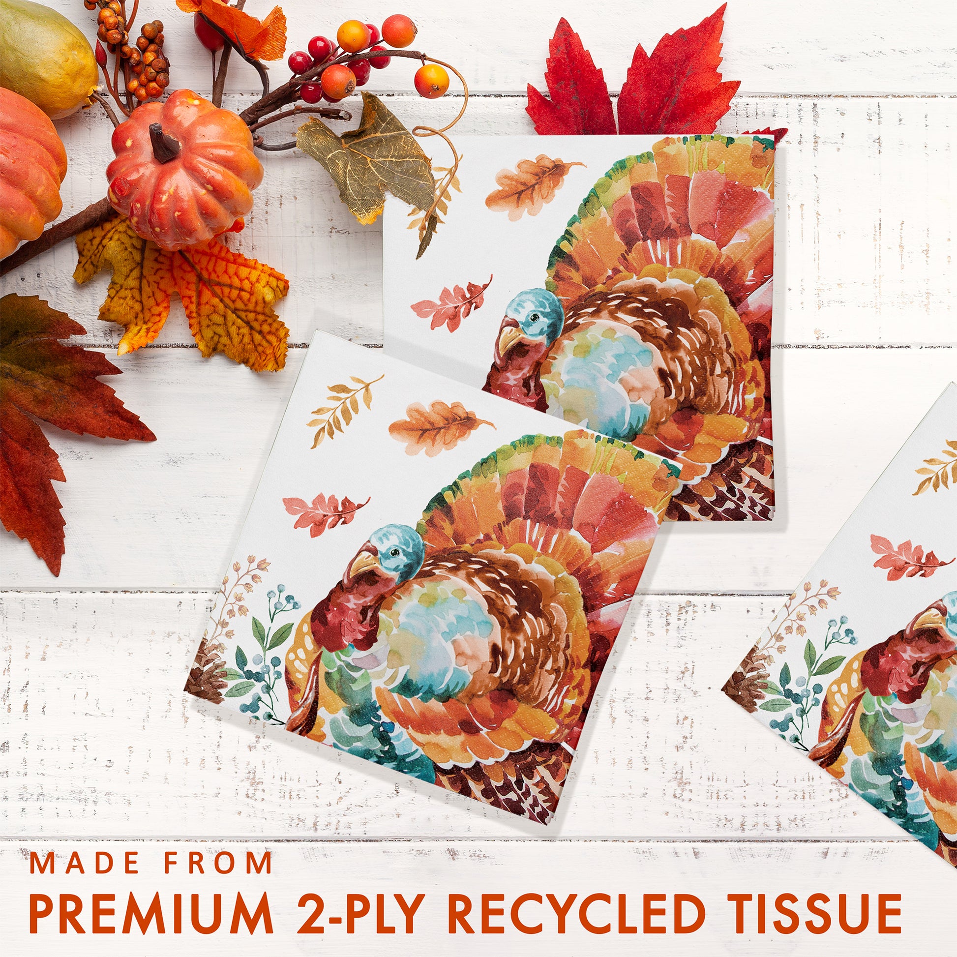 Tasteful Turkey Beverage Napkins 192 ct. Turkey-themed tissues on a white wooden surface with autumn decorations.