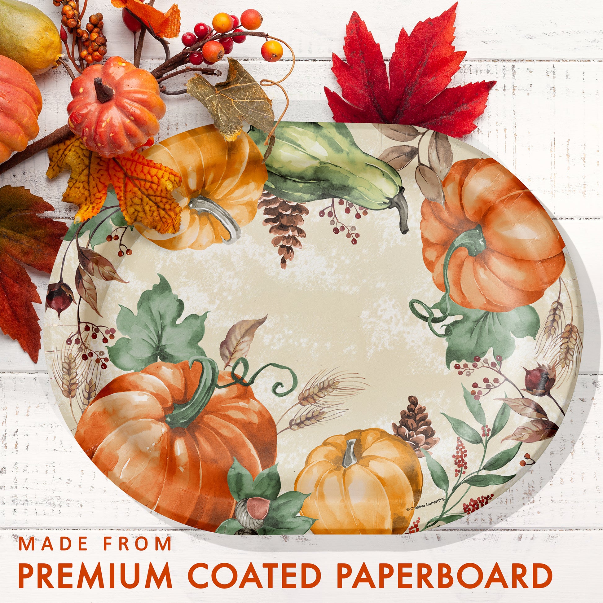 Harvest Delight Oval Dinner Paper Plates 96 ct. Decorative paper plate with pumpkins and leaves on a white background, featuring text about premium coated paperboard.