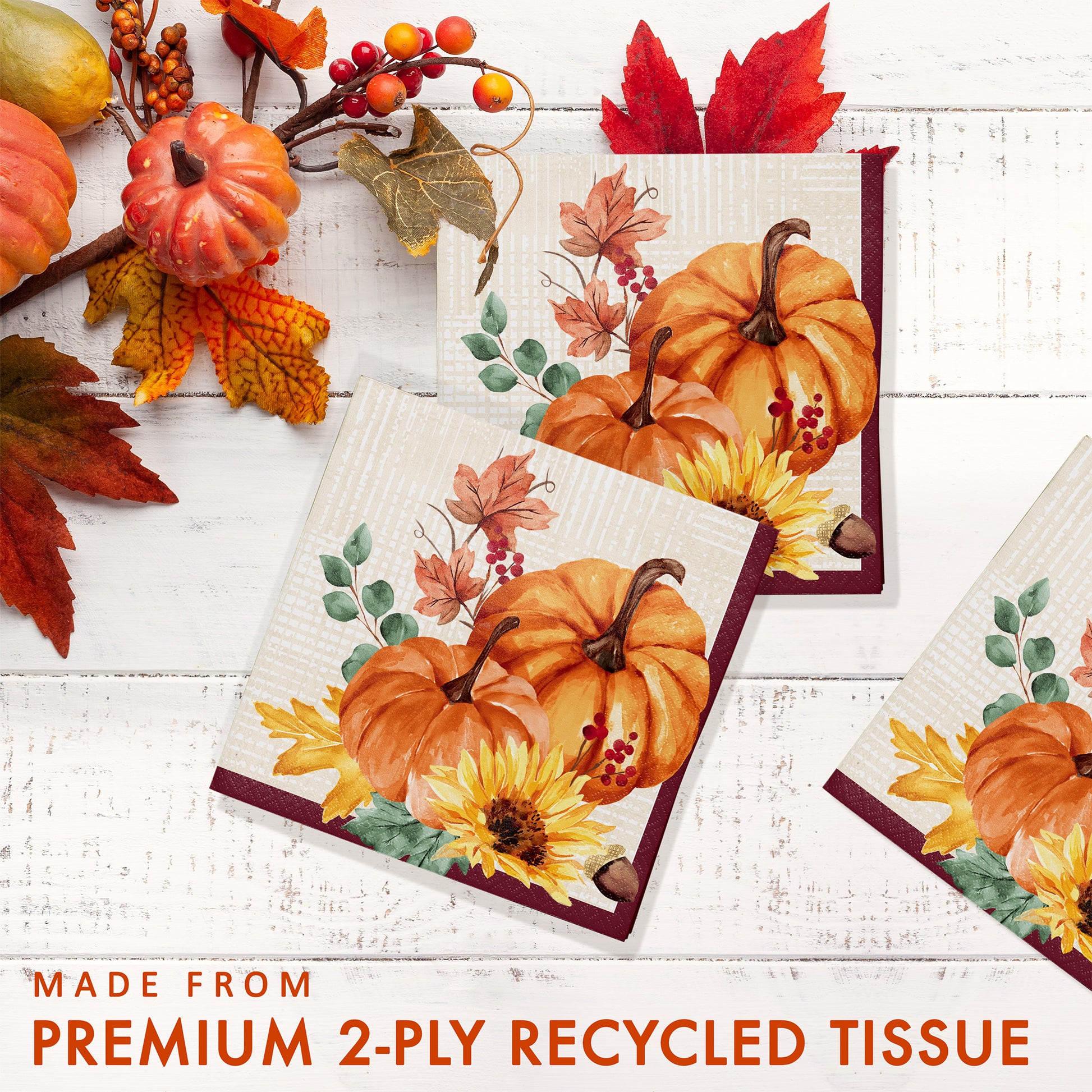 Fall Feast Beverage Napkins 192 ct. Decorative tissue paper with pumpkins and autumn leaves on a white wooden surface.
