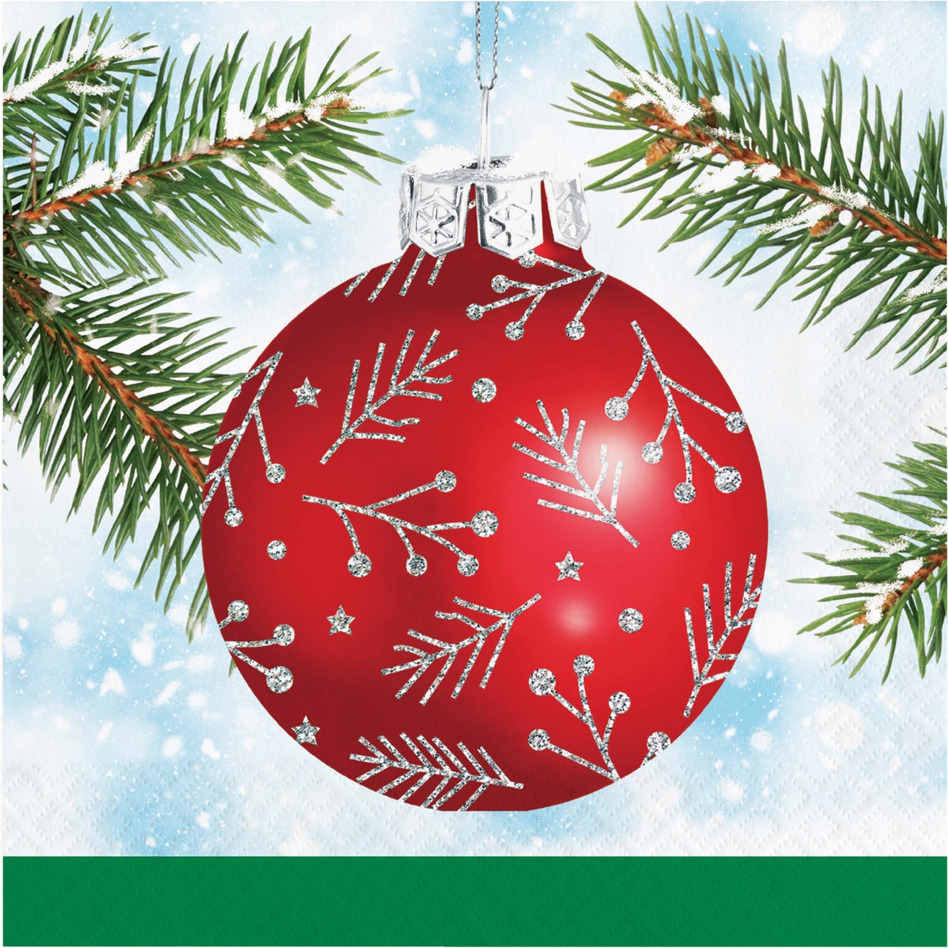 Paper napkin with a red Christmas ornament with silver designs on a branch with snow