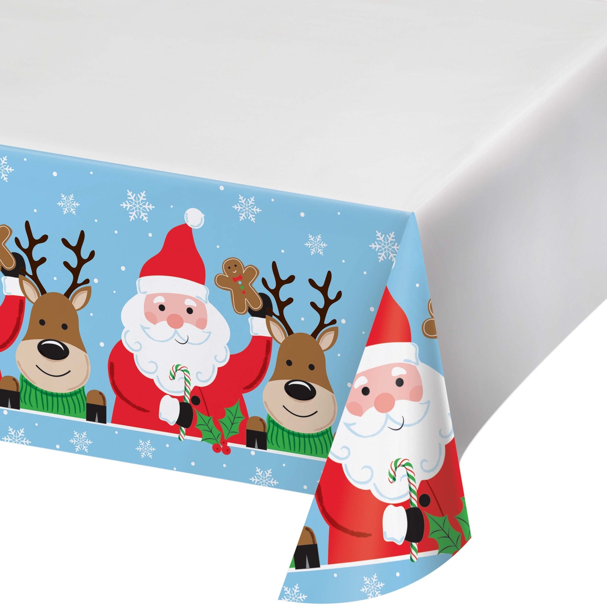 Christmas-themed paper tablecloth with Santa Claus, reindeer, gingerbread bookies and candy canes on a blue background