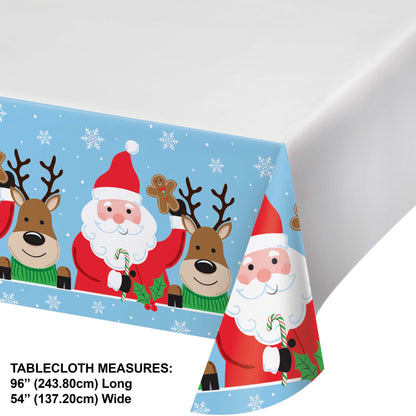 Christmas-themed paper tablecloth with Santa Claus, reindeer, gingerbread bookies and candy canes on a blue background. Dimensions included.