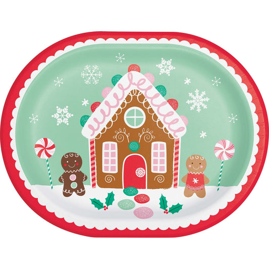 Oval decorative paper plate with a gingerbread house design and gingerbread men on a white background