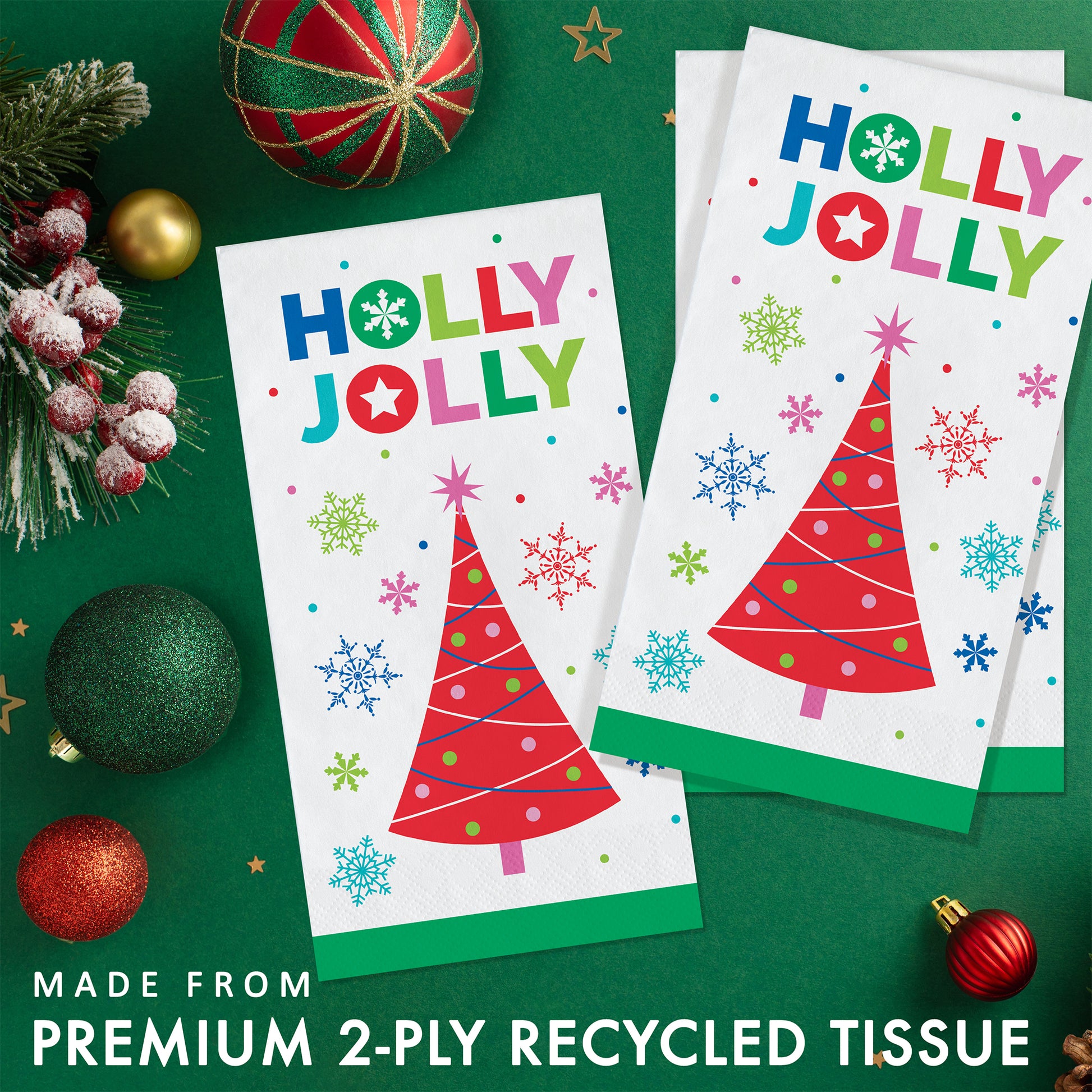 Joyful and Jolly Dinner Napkins 192 ct. 
Two 'Holly Jolly' tissue paper napkins with Christmas tree designs on a green background with festive decorations.