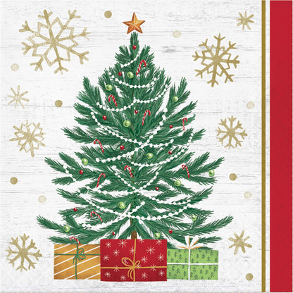 Decorative Christmas paper napkin with a green Christmas tree, presents, and gold snowflakes on a white background.