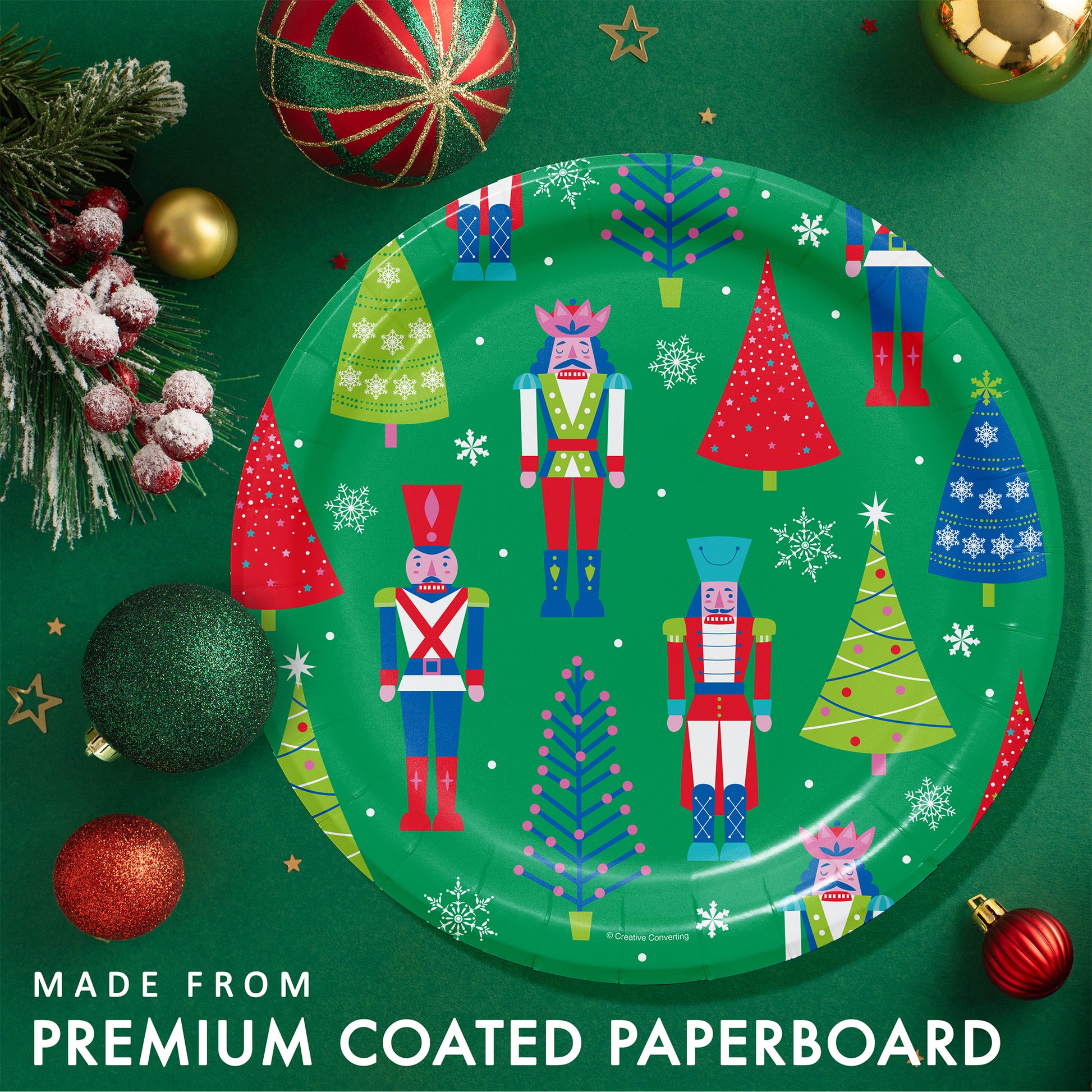Joyful and Jolly Dinner Paper Plates 96 ct. Decorative paper plate with Christmas-themed design on a green background with festive ornaments.
