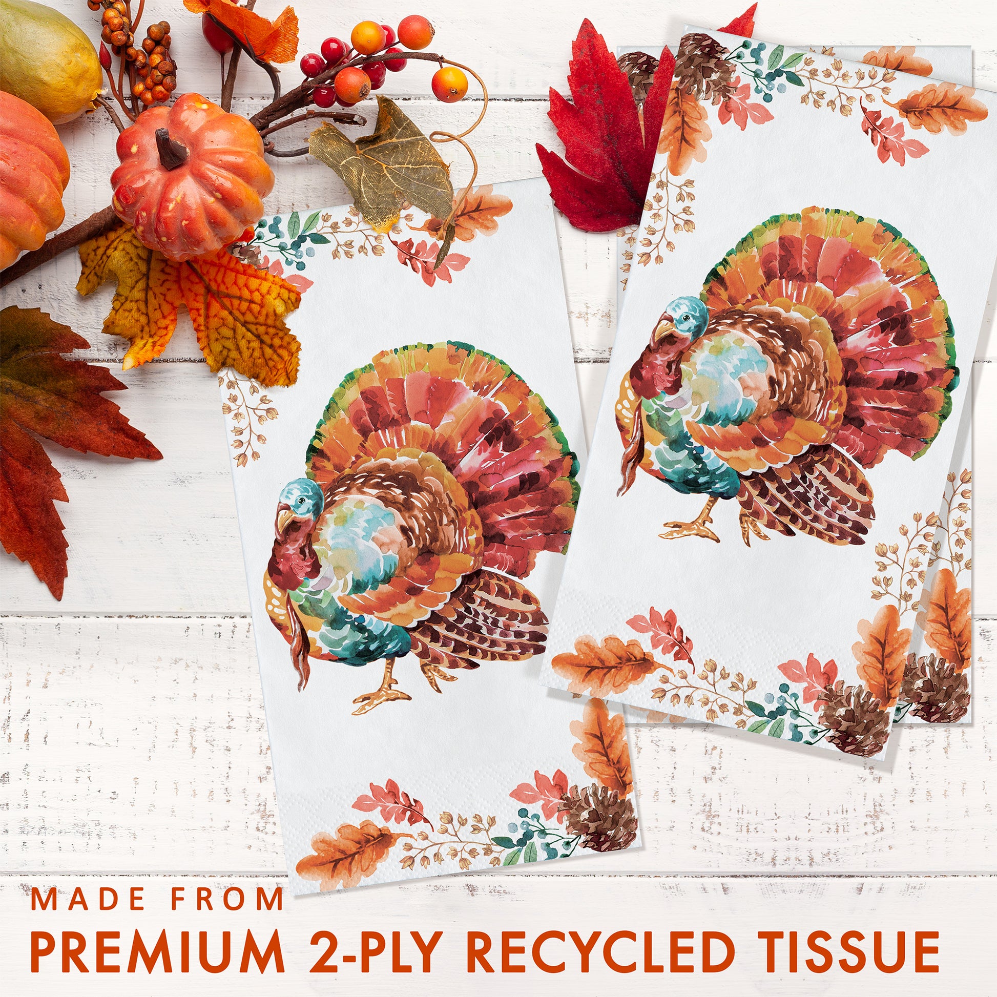 Tasteful Turkey Dinner Napkins 192 ct. Two sheets of decorative tissue paper with turkeys and autumn leaves on a white wooden surface.