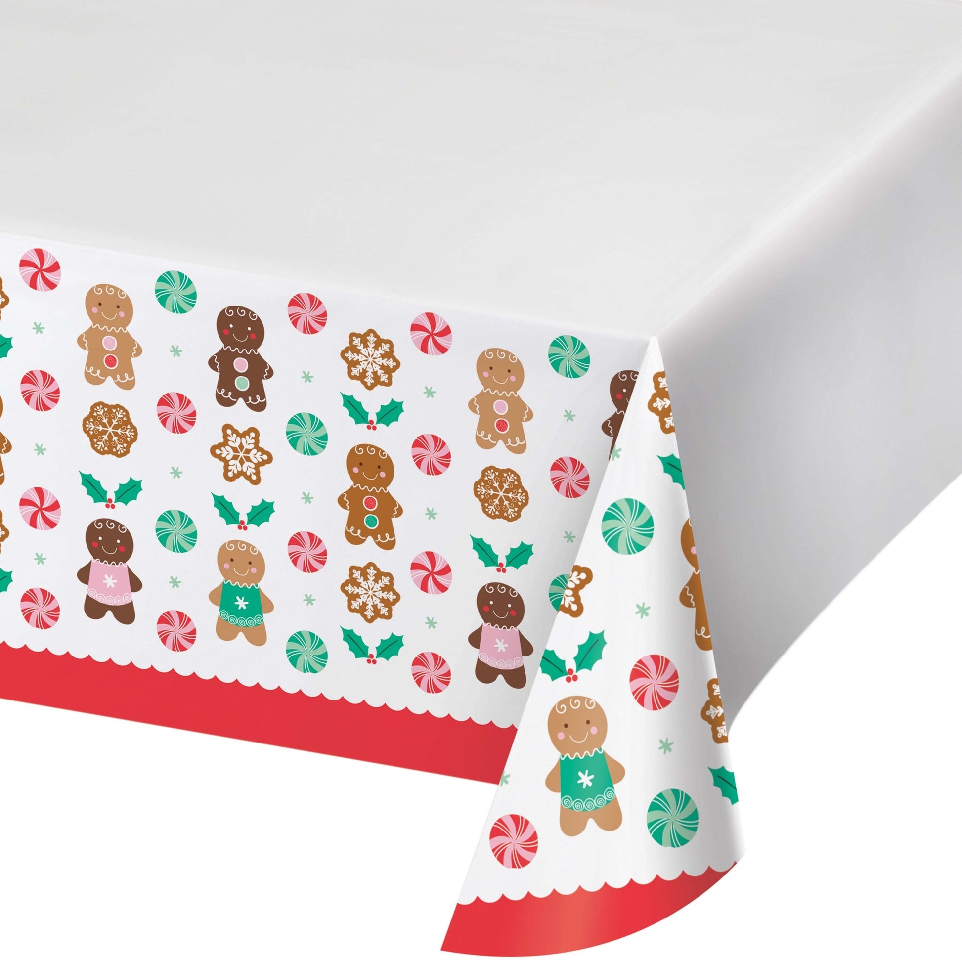 Christmas-themed paper tablecloth with gingerbread men and candy patterns on a white background