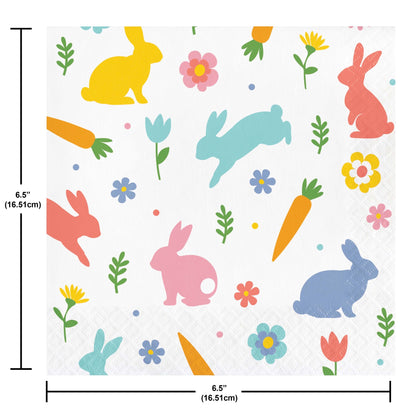 Paper napkin with colorful pattern of bunnies, carrots, and flowers on a white background. Measurements included.