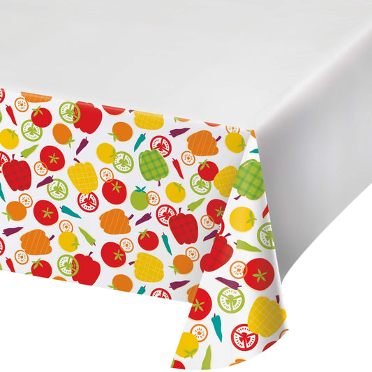 Colorful tablecloth featuring various vegetables on a white background