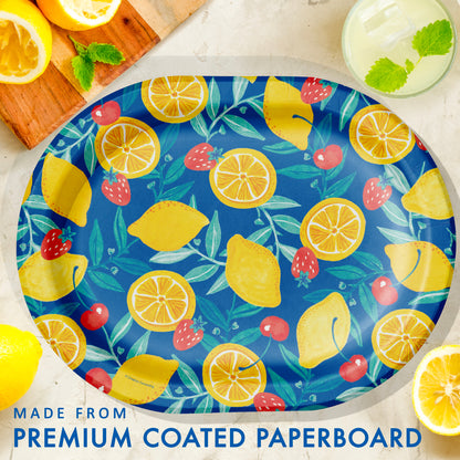 Colorful paper plate with lemon and strawberry pattern on a white surface surrounded by lemons and a drink with mint leaves.