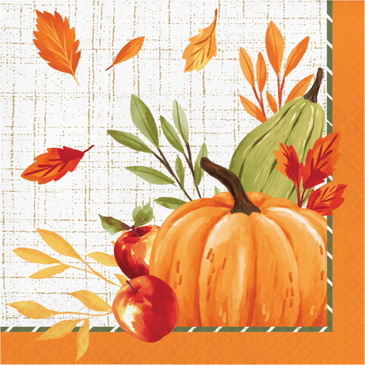 Autumn-themed paper napkin featuring a large orange pumpkin, green squash, red apples, and scattered fall leaves on a cream grid background with an orange border.