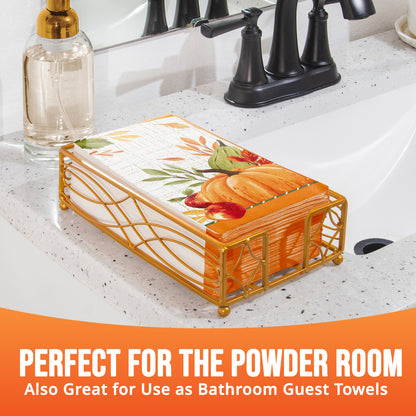 Fall dinner napkin featuring a large orange pumpkin, red apples, a green gourd, and autumn leaves shown in a napkin holder with "Perfect for the Powder Room" text