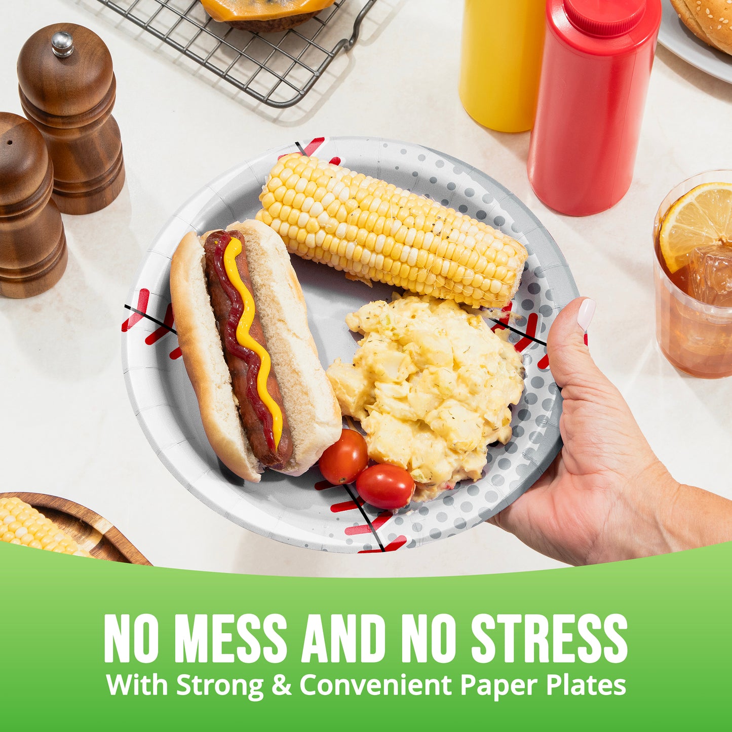Plate of food with a hot dog, corn on the cob, and mashed potatoes, held by a hand, with text 'No Mess and No Stress'.