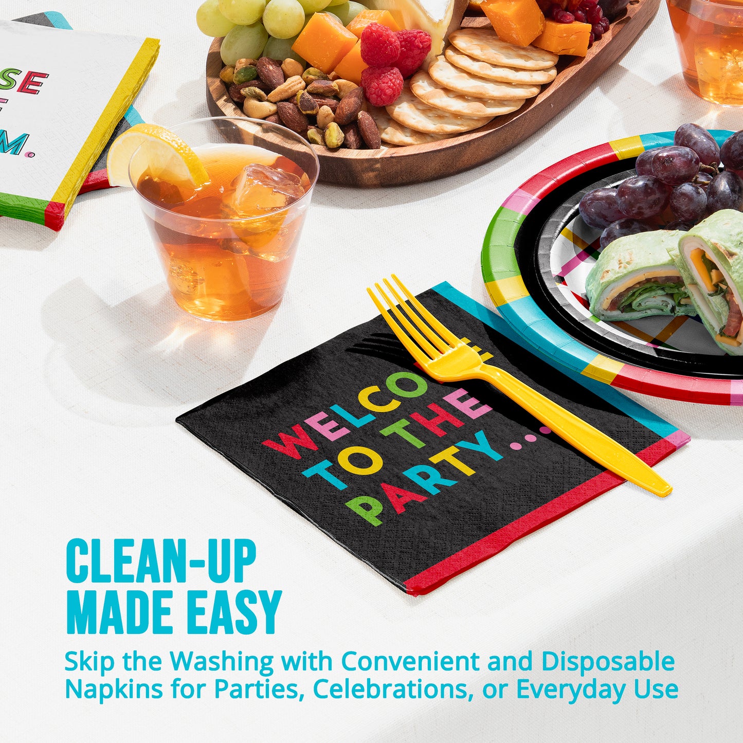 Disposable napkins with colorful text 'Welcome to the Party' on a table setting with food and drinks.