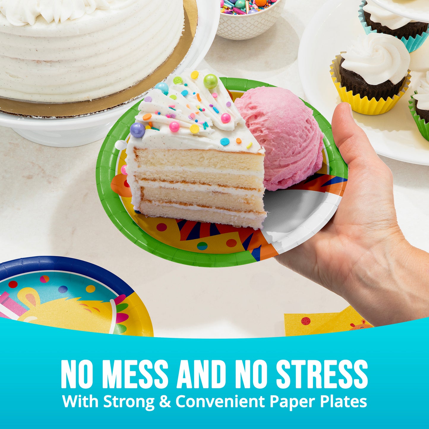 Hand holding a slice of cake with ice cream on a colorful paper plate, surrounded by more cake and ice cream.