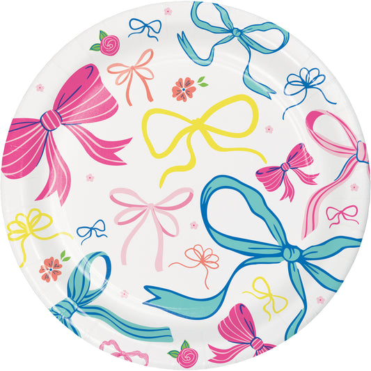 Round paper plate with colorful bow and flower pattern on a white background