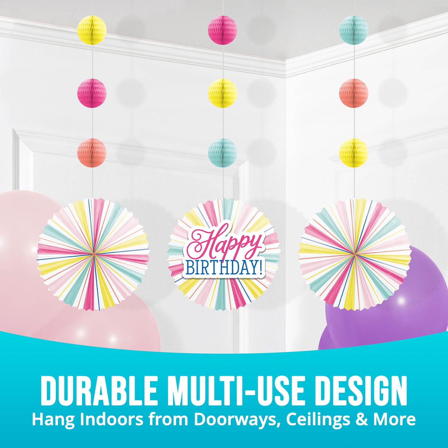 Colorful birthday decorations including hanging paper balls and a 'Happy Birthday!' sign on a white wall.