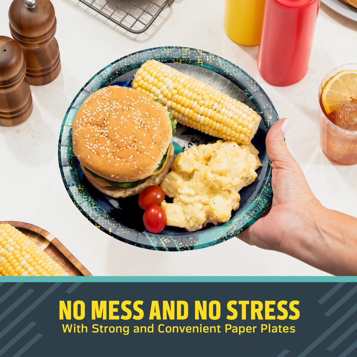 Hand holding a NFL Super Bowl LXI plate filled with a hamburger, corn on the cob, and potato salad. Banner with "No Mess and No Stress" text along the bottom