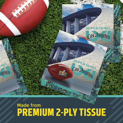 Three NFL Super Bowl LXI themed square napkins on a green turf background next to a football, with a text banner at the bottom reading 'Made from PREMIUM 2-PLY TISSUE'.