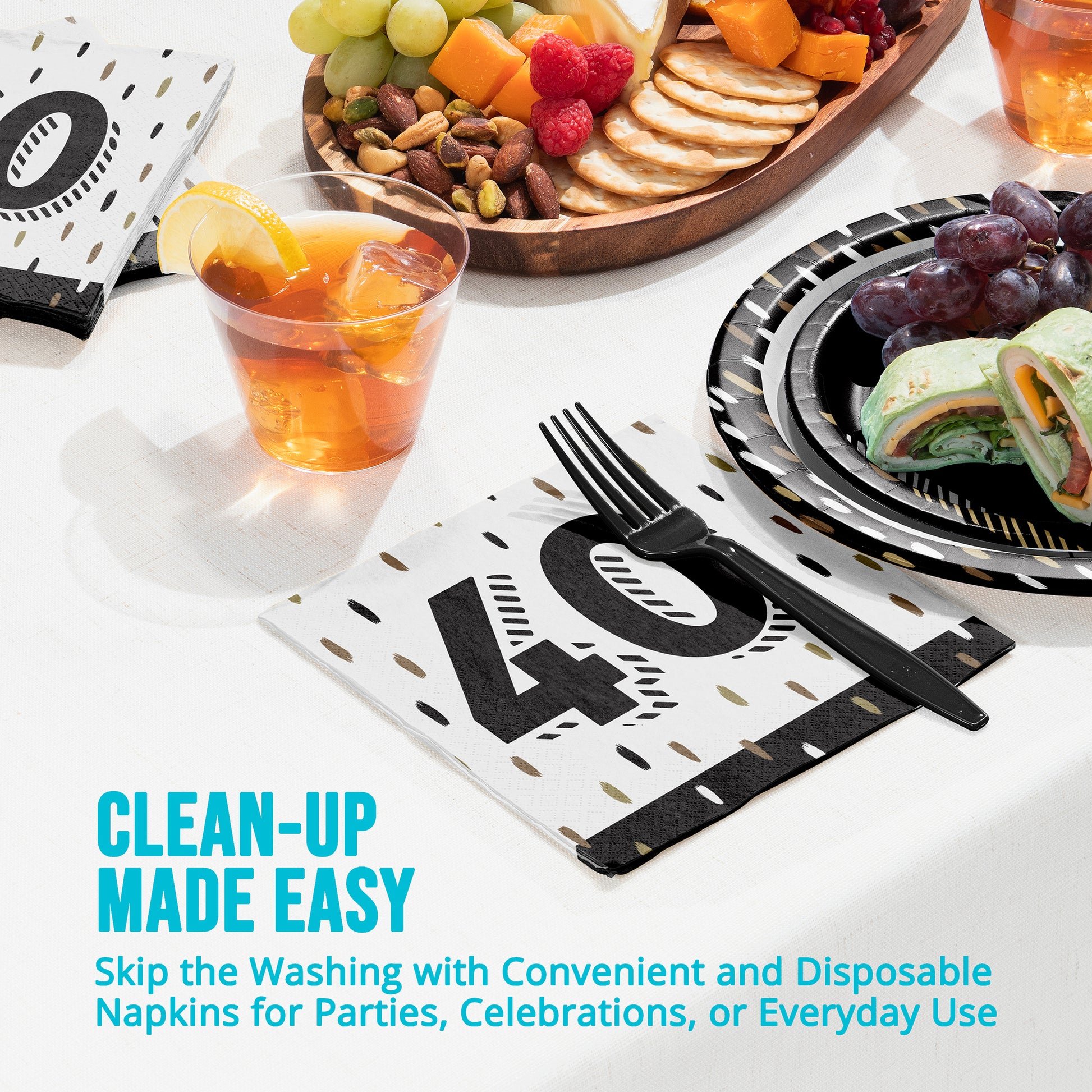 Disposable napkins with "40" on a table with food and drinks.