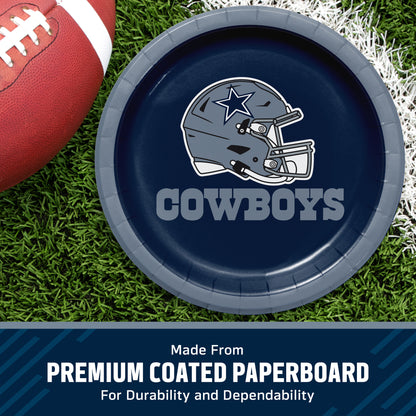 A Dallas Cowboys themed paper plate on a green grass background with a football partially visible. The plate is navy blue with the Cowboys helmet logo and 'COWBOYS' text in white.