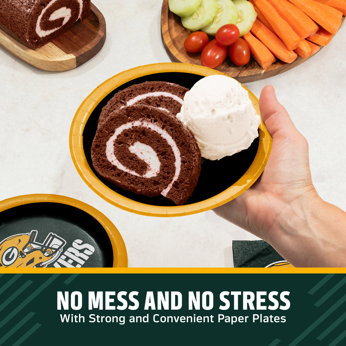 Hand holding a Green Bay Packers plate filled with chocolate cake and ice cream. Banner with "Clean-Up Made Easy" text along the bottom