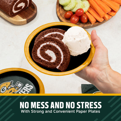 Hand holding a Green Bay Packers plate filled with chocolate cake and ice cream. Banner with "Clean-Up Made Easy" text along the bottom