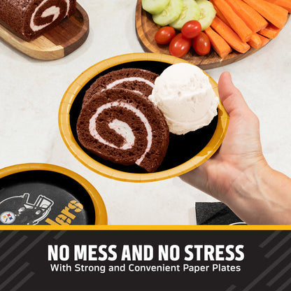 A hand holds a black Pittsburgh Steelers paper plate with a yellow rim, topped with a chocolate cake roll and a scoop of vanilla ice cream. Other paper plates and food props are visible on a light countertop, with a promotional text banner at the bottom.