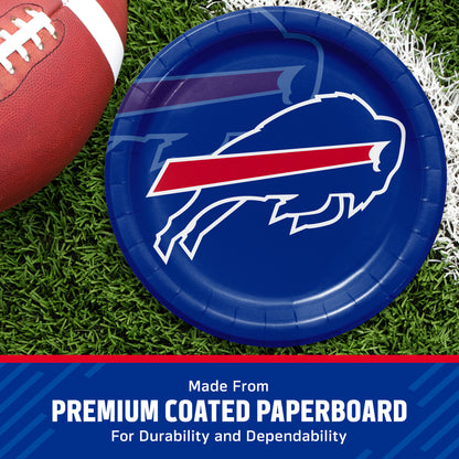 A round blue paper plate featuring the Buffalo Bills charging buffalo logo, styled on a green turf background with a football partially visible. A blue banner at the bottom reads 'Made From PREMIUM COATED PAPERBOARD For Durability and Dependability'.