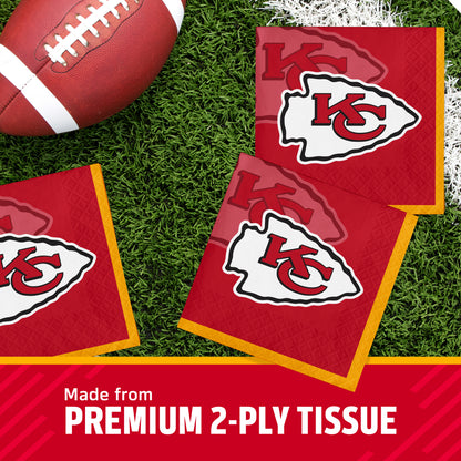 Kansas City Chiefs themed premium 2-ply tissue napkins on a green turf background with a football prop, featuring the team's KC logo and a red promotional banner at the bottom.