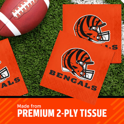 Three Cincinnati Bengals themed square napkins on a green turf background next to a football, with a text banner at the bottom reading 'Made from PREMIUM 2-PLY TISSUE'.