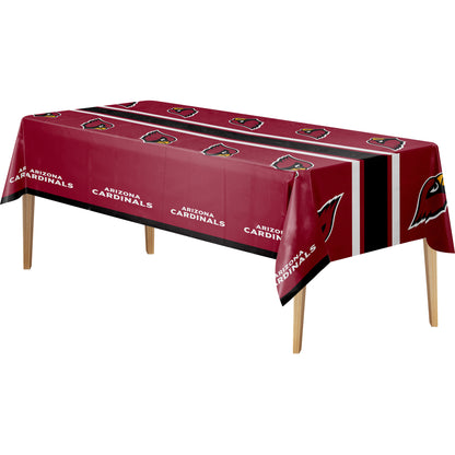 A rectangular table covered with a Arizona Cardinals themed tablecloth, shown on a plain white background. The tablecloth is dark red with black and white stripes, repeating team logos, and the words 'ARIZONA CARDINALS'.