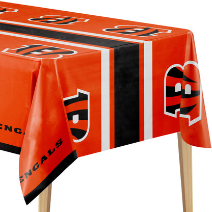 Close-up image of Cincinnati Bengals tablecloth with orange background, "B" logo, and "BENGALS" text on a wooden table.