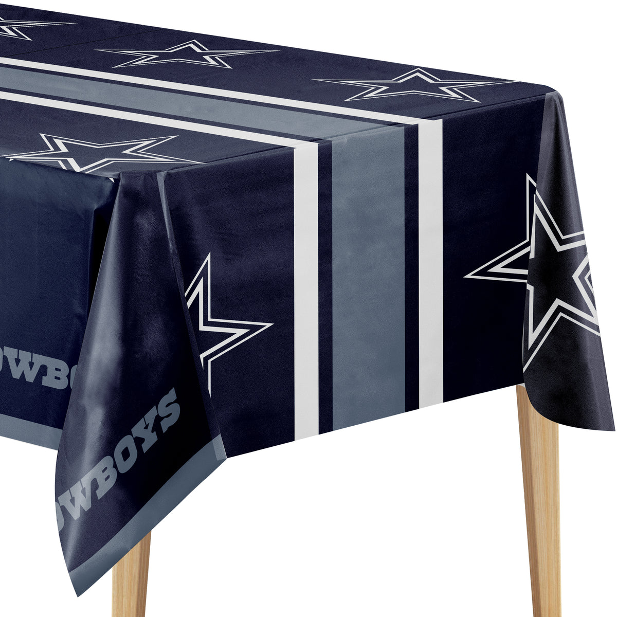Close-up image of Dallas Cowboys tablecloth with navy background, Dallas Cowboys star logo, and "COWBOYS" text on a wooden table.