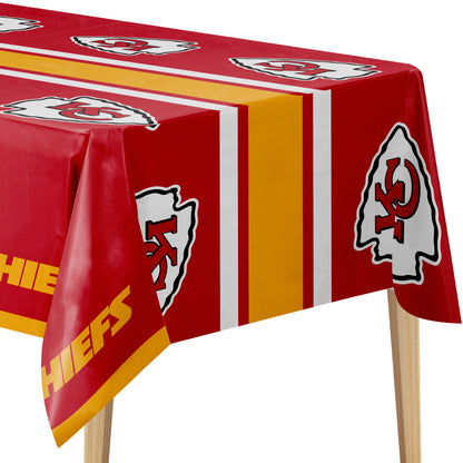Kansas City Chiefs themed rectangular tablecloth with a red background, gold and white vertical stripes, and repeated team logos, shown draped over a table on a white background.