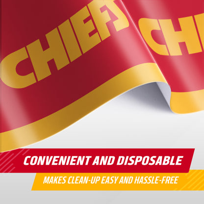 A close-up of a red and yellow Chiefs tablecloth with bold yellow lettering with 'CHIEFS' on a red background, shown with text overlays reading 'CONVENIENT AND DISPOSABLE' and 'MAKES CLEAN-UP EASY AND HASSLE-FREE'.