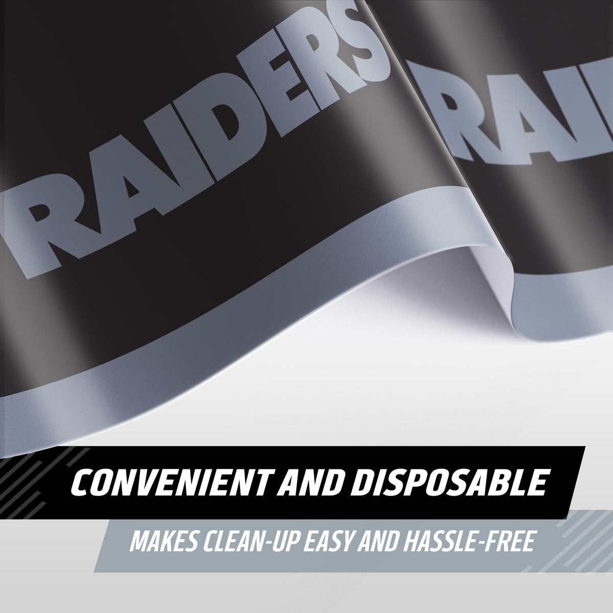 A close-up of a Raiders tablecloth with bold silver lettering with 'RAIDERS' on a black background, shown with text overlays reading 'CONVENIENT AND DISPOSABLE' and 'MAKES CLEAN-UP EASY AND HASSLE-FREE'.