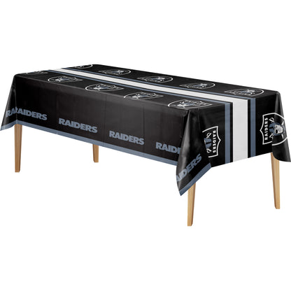 Las Vegas Raiders tablecloth with black background, white and silver Raiders logo, and "RAIDERS" text on a wooden table