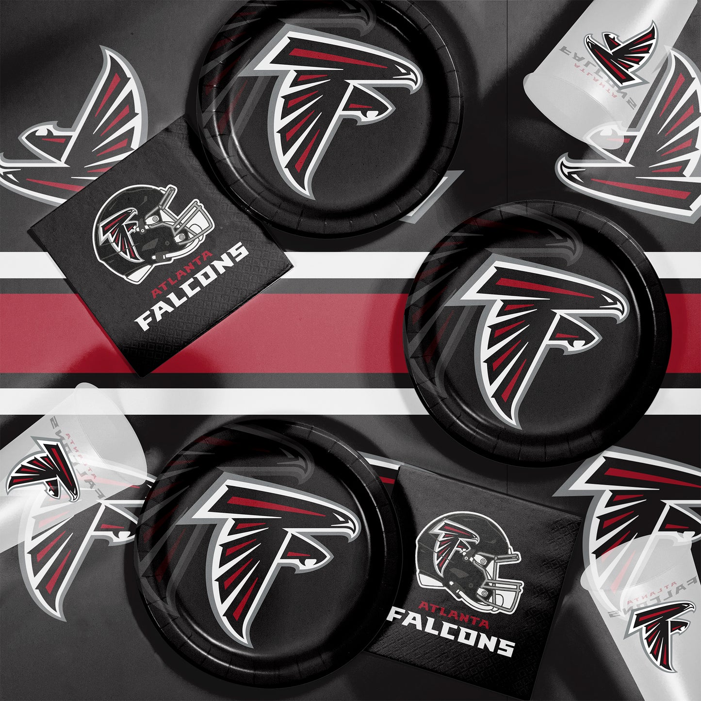 Collection of Atlanta Falcons plates, napkins and cups on a black background.